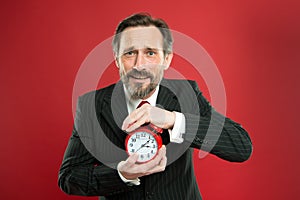 Time management skills. How much time left till deadline. Manager with alarm clock. Man bearded businessman hold clock