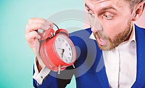 Time management skills. How much time left till deadline. Time to work. Man bearded surprised businessman hold clock