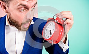 Time management skills. How much time left till deadline. Time to work. Man bearded surprised businessman hold clock