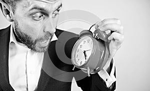 Time management skills. How much time left till deadline. Time to work. Man bearded surprised businessman hold clock