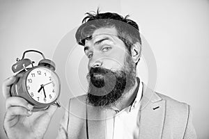 Time management skills. Time to work. Man bearded sleepy tired businessman hold clock. Stress concept. Hipster stressful