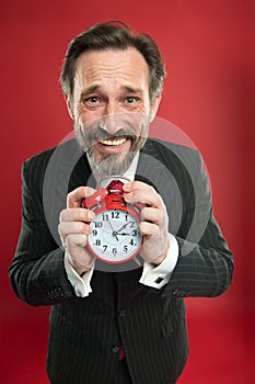 Time is merciless. Businessman formal suit hold alarm clock. Deadline concept. Last minute. Time management. Schedule photo