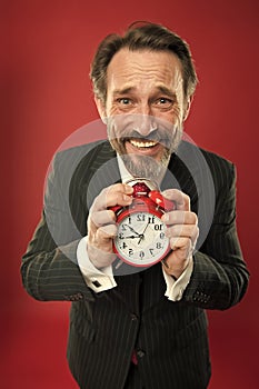 Time is merciless. Businessman formal suit hold alarm clock. Deadline concept. Last minute. Time management. Schedule photo