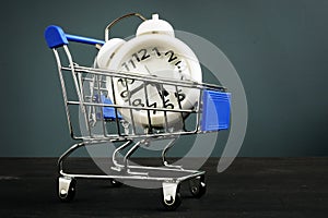 Time is money. Alarm clock in the shopping cart. Buy time