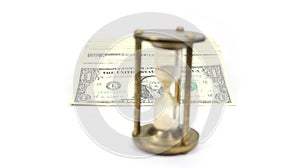 Time Is Money with Blurred Metal Sand Timer In Front, And Money Behind In Focus