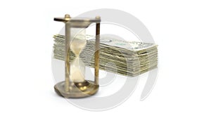 Time Is Money with Metal Sand Timer Blurred, Angled Money In Focus