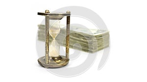 Time Is Money with Metal Sand Timer In Focus, Angled Money Blurred