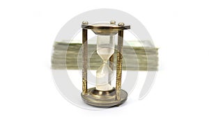 Time Is Money with Metal Sand Timer In Focus, Stack Of Money Blurred