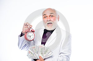 Time is money. Senior man pensioner hold cash money and clock. Earn money profit. Banking and money savings. Savings