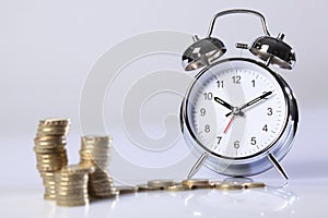 Time is money silver clock and gold pound coins