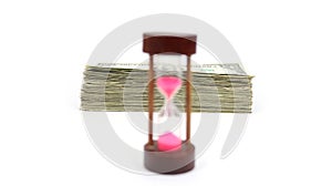 Time Is Money With Stack Of Cash In Focus Behind A Wood Sand Timer Up Front And Blurred