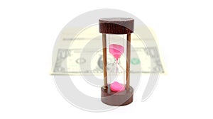 Time Is Money with Wood Sand Timer, White Sand, In Focus, Money Laid Out Blurred In Back