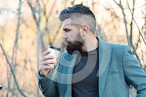 Time for myself. Hipster hold paper coffee cup. Relaxing coffee break. Businessman bearded guy drink coffee outdoors