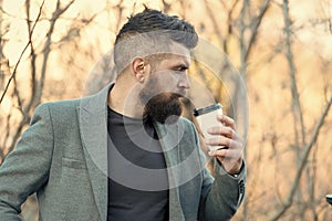 Time for myself. Hipster hold paper coffee cup. Relaxing coffee break. Businessman bearded guy drink coffee outdoors