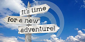 It is time for a new adventure - wooden signpost with three arrows