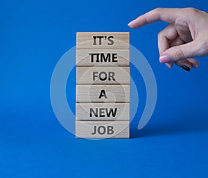 It is time for a new job symbol. Concept words It is time for a new job on wooden blocks. Businessman hand. Beautiful blue