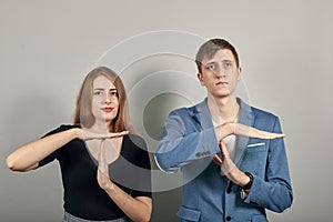Time out gesture, break, doing t symbol, sign with help of hands. Young couple