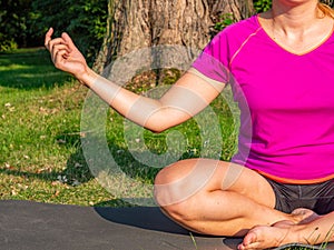 Time-out woman meditating in the park