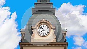 Time passing, historical clock running with movement of clouds.