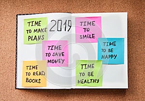 Time for planning bright stickers with different motivation notes in notebook