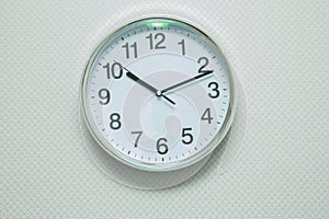 Time Punctual Second Minute Hour Concept . Wall white clock and shelf at abstract white background . close up of an