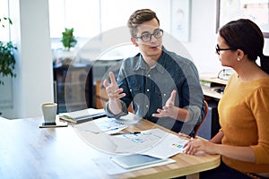 Time for a quick brainstorm. Cropped shot of two coworkers having a discussion in the office.