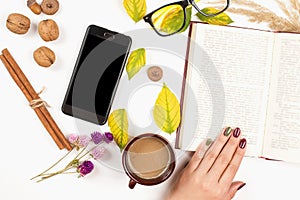 Time for reading. Autumn background with opened book, cup of coffee. Autumn mood, lifestyle, season. Autumn flat lay