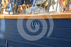 Danish three-masted schooner Loa. Name of ship on wooden starboard closeup