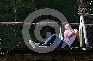 Time for relax , lady sitting on wooden bridge