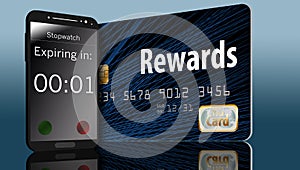 Time is running out on expiring credit card rewards and a time on a cell phone next to a card makes this point. photo
