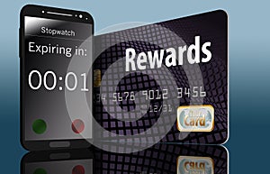 Time is running out on expiring credit card rewards and a time on a cell phone next to a card makes this point. photo