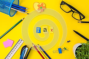 Time for Taxes. Money Financial Accounting. Taxation Concept with office suplies at yellow background