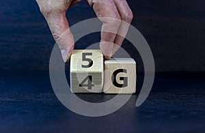 Time to 5G. Male hand turns a wooden cube and changes sign 4G to 5G. Technology, business, network, communication and 5g concept.