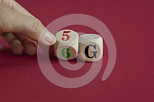 Time to 6G symbol. Male hand turns wooden cube and changes sign 5G to 6G. Technology, business, network, communication and 6G
