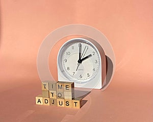 Time to adjust - adjusting or changing the time on white clock.