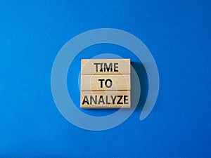 Time to Analyze symbol. Concept word Time to Analyze on wooden blocks. Beautiful blue background. Business and Time to Analyze
