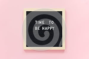 Time to be happy. Motivational quote on letterboard on pink background. Top view Flat lay Concept inspirational quote of the day