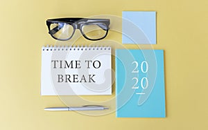 TIME TO BREAK inscription, glasses, notebook