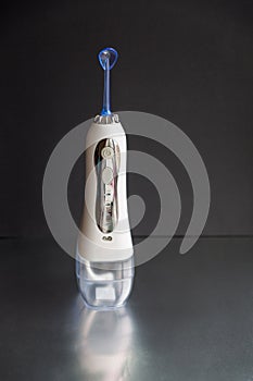 Time to brush your teeth. Oral irrigator on a black background