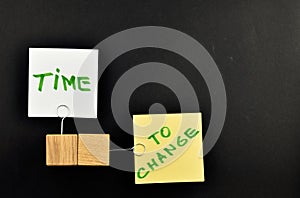 Time to change, Two paper notes on black background for presenta