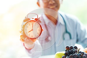 Time to diet doctor with clock and fruit good healthy