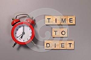 Time to Diet inscription and alarm clock on gray background