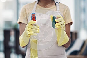 Time to eliminate those germs. an unrecognisable woman using rubber gloves and disinfectant to clean her home.