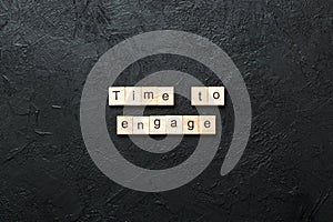Time to engage word written on wood block. Time to engage text on table, concept photo