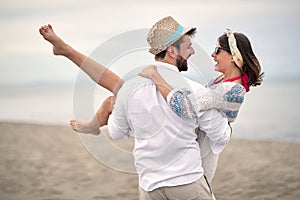 Time to enjoy outdoors. Young couple in an embrace.Romantic man and woman on sea beach
