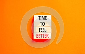 Time to feel better symbol. Concept words Time to feel better on wooden block. Beautiful orange table orange background.