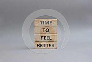 Time to feel better symbol. Wooden blocks with words Time to feel better. Beautiful grey background. Medicine and Time to feel