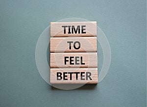 Time to feel better symbol. Wooden blocks with words Time to feel better. Beautiful grey green background. Medicine and Time to