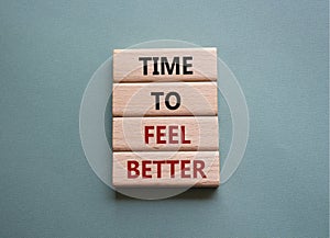Time to feel better symbol. Wooden blocks with words Time to feel better. Beautiful grey green background. Medicine and Time to