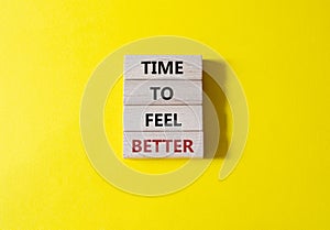 Time to feel better symbol. Wooden blocks with words Time to feel better. Beautiful yellow background. Medicine and Time to feel